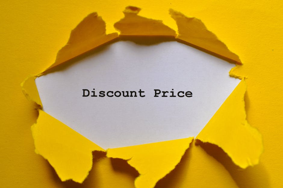 A close-up image of a yellow piece of torn paper with jagged edges, revealing a white inner layer with the words 'Discount Price' printed in black typewriter-style font. The torn paper creates a hexagonal opening, contrasting with the bright yellow background. The scene conveys the idea of a special offer or promotional discount, which could be related to waste management or rubbish clearance services provided by local specialists such as those on the domain rubbishclearancekingstonuponthames.com, emphasizing affordable or alternative solutions for waste disposal and on-site clearance. The lighting is even, highlighting the texture of the torn paper and the crispness of the printed message, suitable for a visual representing discounts or savings in the context of private rubbish removal or independent waste collection options.